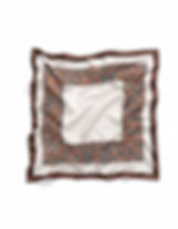 A square satin scarf features a cream center with a brown and orange geometric interlocking diamond border.
