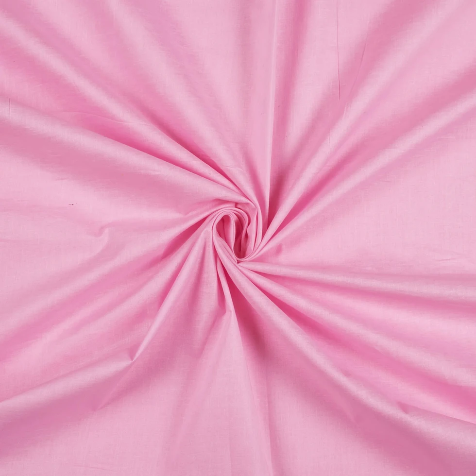 Blush Petal Plain Cotton Cambric Fabric displayed with a swirl pattern.