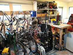 Clycycles first bikes on a wall rack in a garage