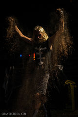 Cinematic portrait by Hawaii Photographer  Grant Uchida capturing dynamic motion and golden sand in dramatic light