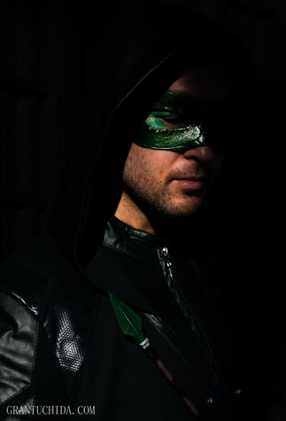 Cinematic cosplay portrait by hawaii photographer Grant Uchida capturing a mysterious masked man in dramatic low light. Green Arrow