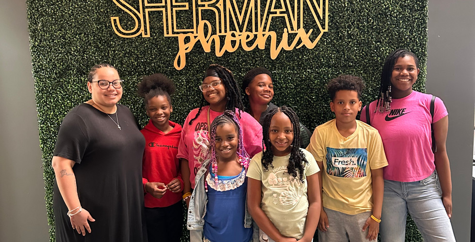 Group of Children in front of the Sherman Phoenix Logo Living Wall