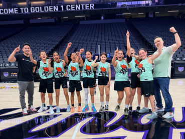 Youth basketball team and coaches cheer at Golden 1 Center.