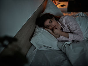 Worried Woman Lying Awake in Bed at Night