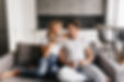 couple-love-sitting-sofa-holding-cups-looking-each-other-smiling-romantic-couple-enjoys-mo