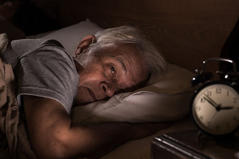 Depressed senior man lying in bed cannot