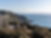 Modern clifftop accommodation, outdoor seating, vast ocean, hills, Wellington accommodation.