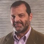 Picture of Dr. Mark Pedrotty, short brown hair, brown eyes, beard, fair skin, smiling, shirt and sport coat