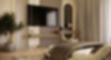 Modern bedroom interior featuring large TV, vanity mirror, and neutral tones.
