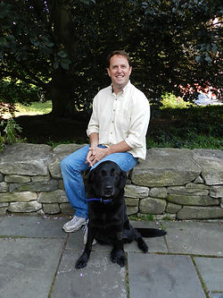 Kevin Brady, the owner of Joseph M. Brady Co., Inc. with Jessy the dog 