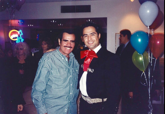 Mariachi Los Vaqueros director Héctor Castro with legendary Mexican singer Vicente Fernández, representing the legacy of mariachi music in Los Angeles.