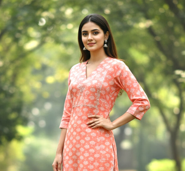 Cotton Exclusive peach printed cotton kurta with V-neckline, straight fit, and three-quarter sleeves.