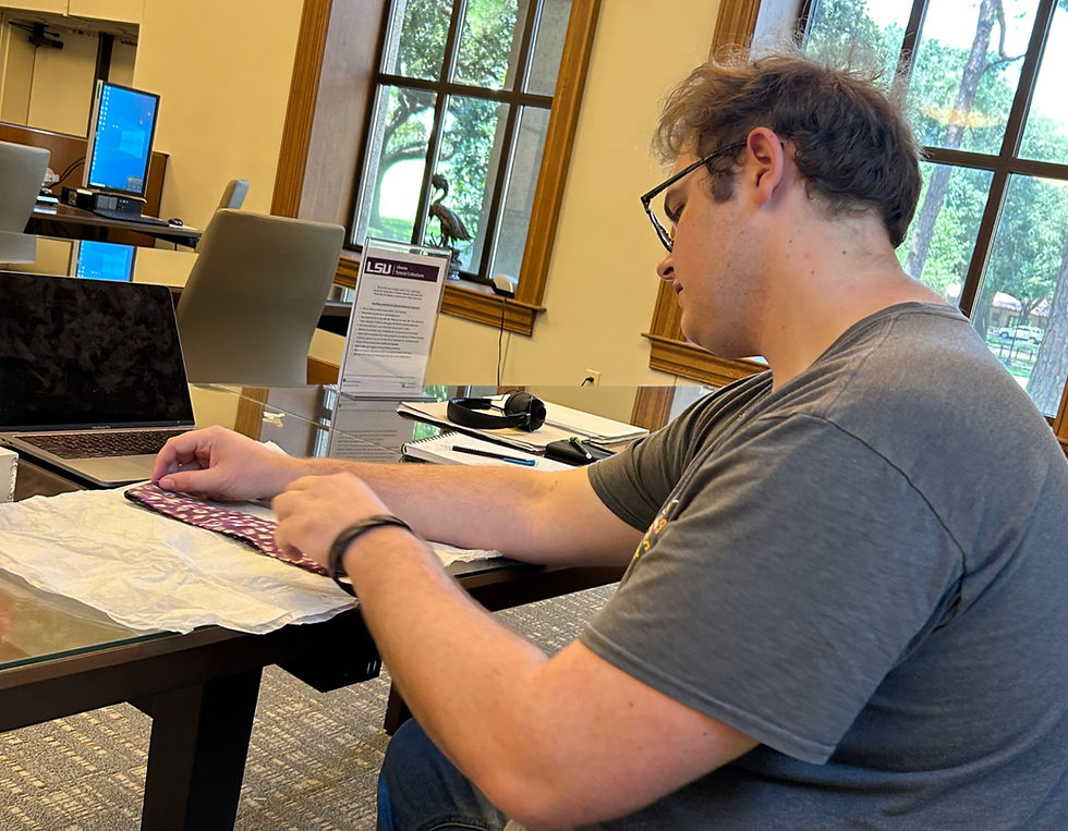 Wyatt holds tie worn by Huey Long
