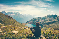 Traveler Man relaxing meditation with serene view mountains and lake landscape Travel Life