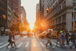 Busy intersection is crowded with people and cars on 5th Avenue and 23rd Street in New Yor