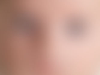 A 6 month old infant gazes intently into the camera with large crystal blue eyes and a clear open gaze. The infant is the baby from a past life regression story based during the late medieval times.