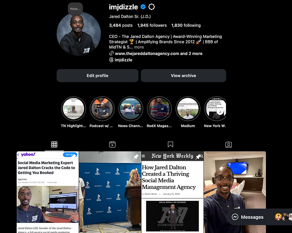 A person sitting at a modern desk using a desktop computer to view Instagram’s updated layout, showing four posts across the profile grid. The screen displays the verified account “imjdizzle,” representing the new desktop interface update.