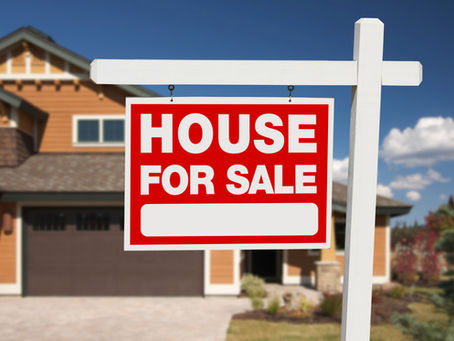 for sale sign in front of house