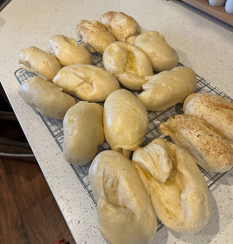 A cooling rack of hot dog buns