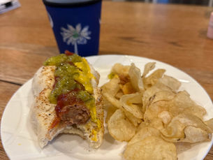 Hot dog in a hot dog bun with chips
