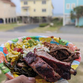 A plate full of BBQ and ribs and sides