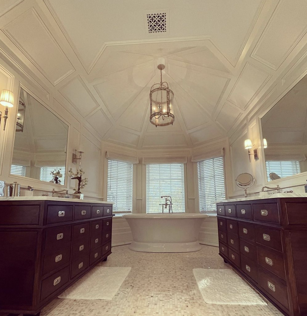 Luxury master bathroom with double vanities and soaking tub.