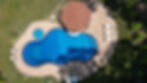 Aerial view of a backyard pool with a hot tub, a patio, and a gazebo