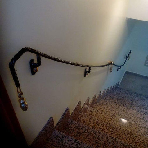 Wrought iron handrail along a stone staircase