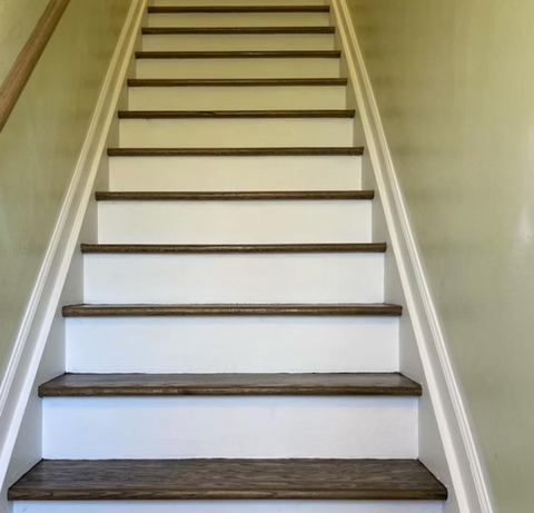 Newly painted white stairs with wood trim