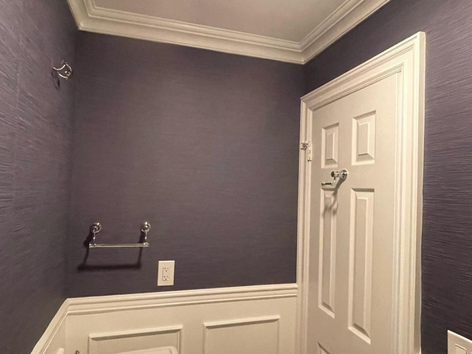 Purple walls, white trim, powder room