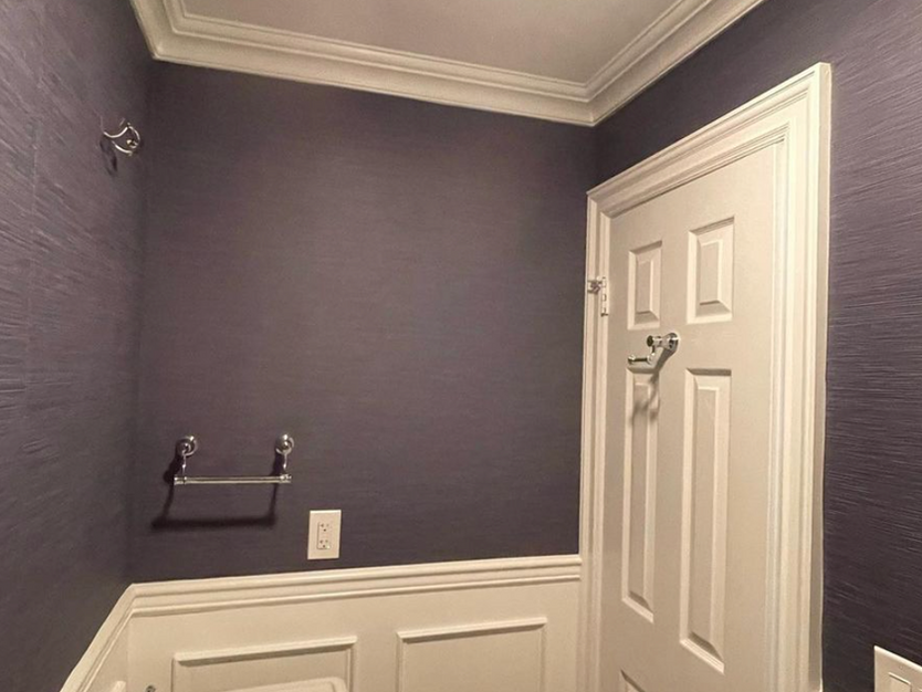 Purple bathroom with white trim and sink