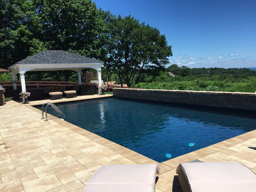 Swimming pool with patio and gazebo overlooking a scenic view