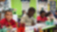 NACS children writing at table in classroom