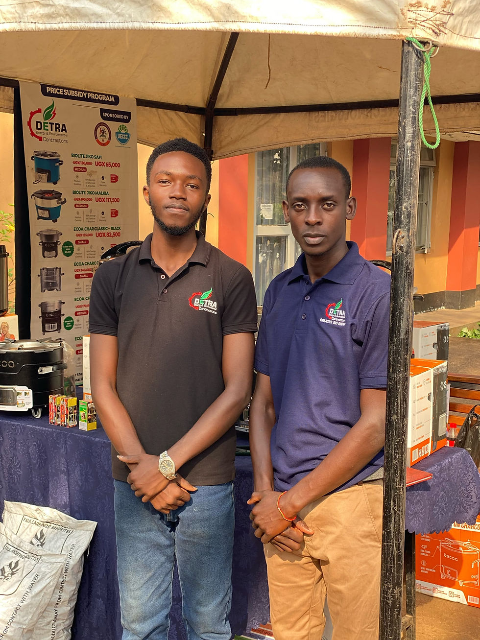 Some of the detra team members at the sjow posing in front of some the imprived cookstoves that were being displayed at the show.