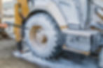 Washing a wheeled tractor at a car wash with a foam solution.jpg