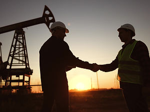 handshake business oil contract. handshake worker and businessman shaking hands against su