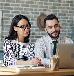 colleagues looking at laptop screen in m