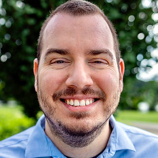 Male therapist smiling at the camera