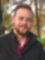 A smiling bearded male therapist, Logan Mahan, LCSW