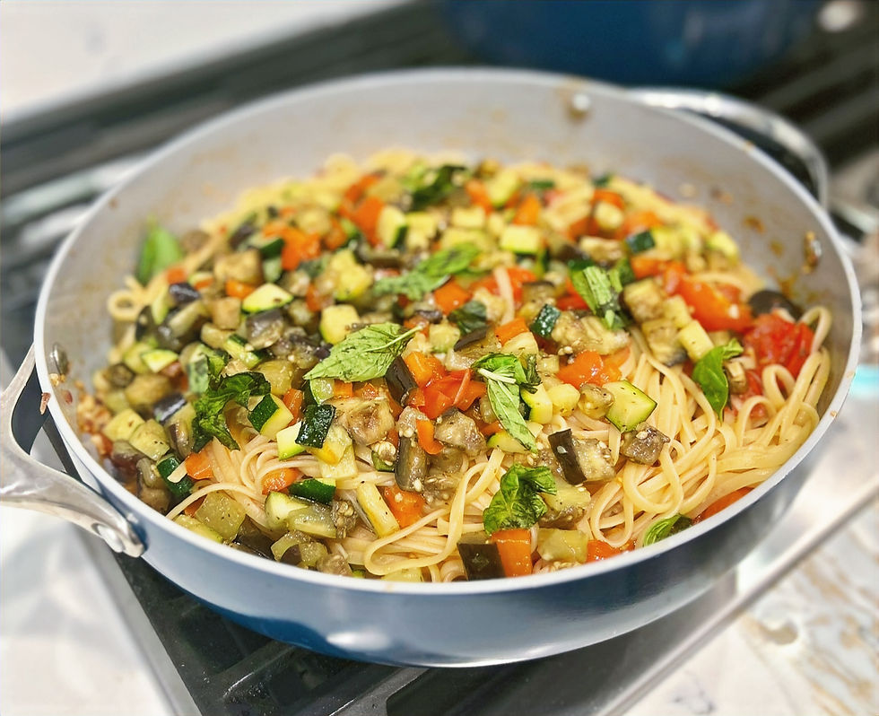 Eye-level view of a bowl of rustic Italian veggie linguine with fresh basil and cherry tomatoes