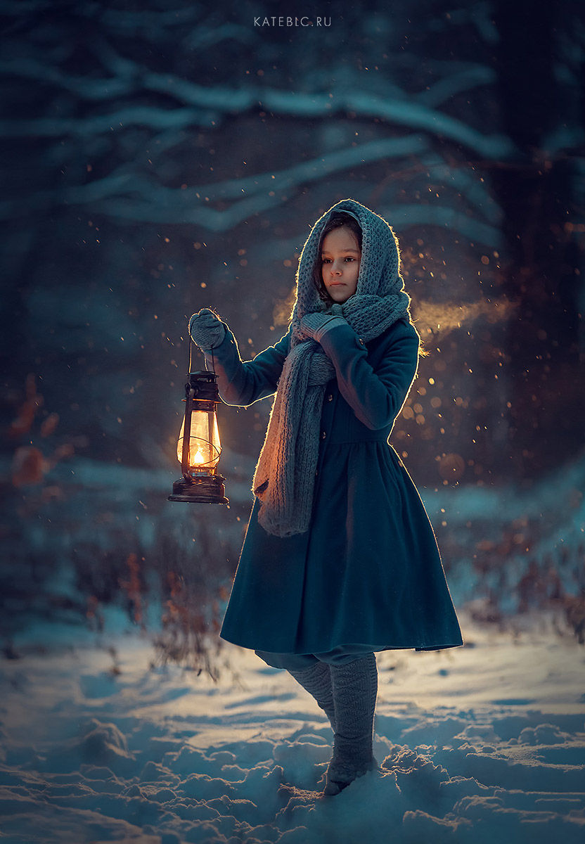 Girl with a lantern walking in the night forest