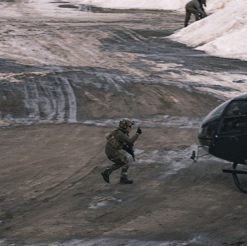 Airsoft players approaching helicopter at milsim