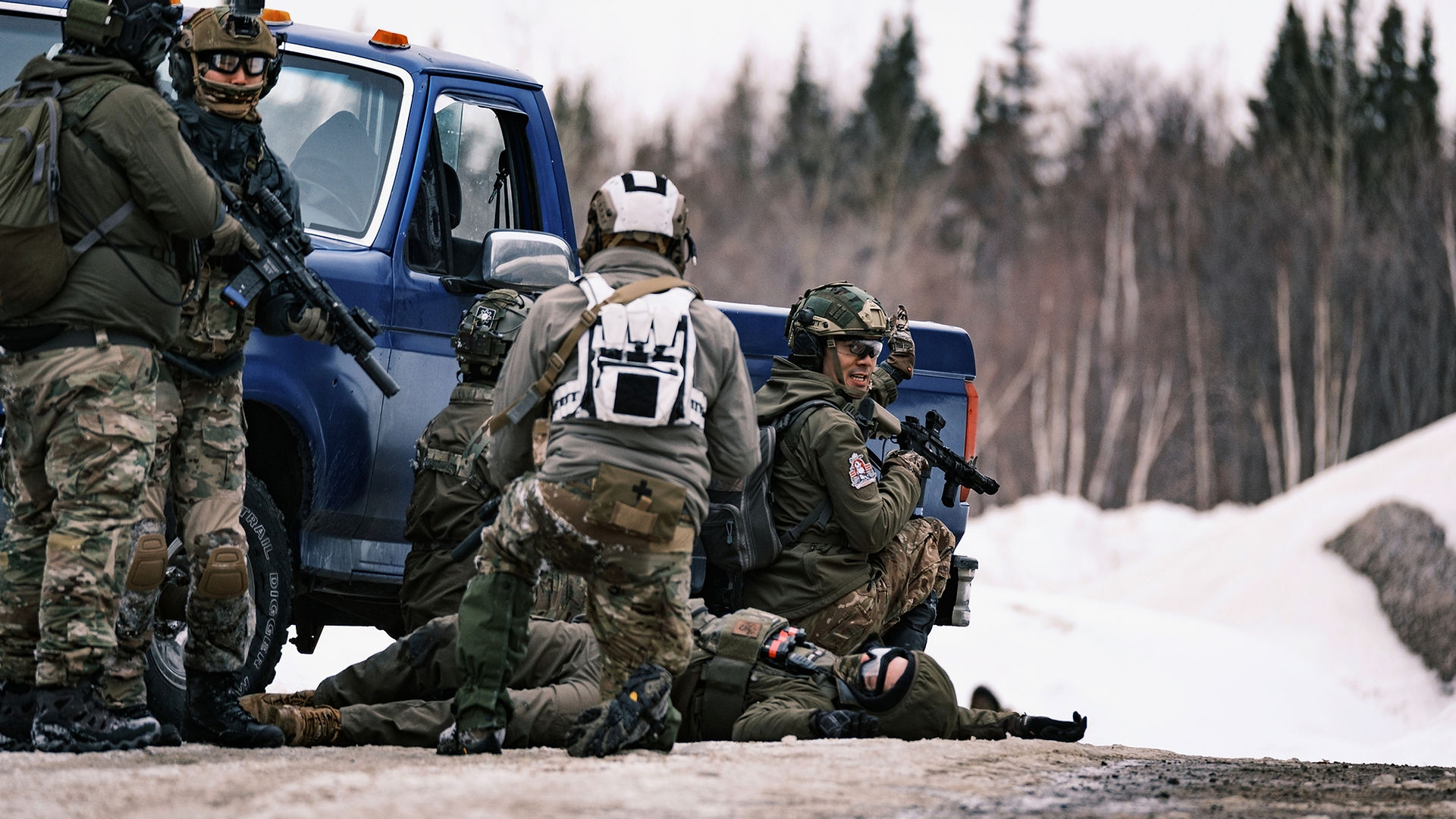 Airsoft players using truck as cover at milsim