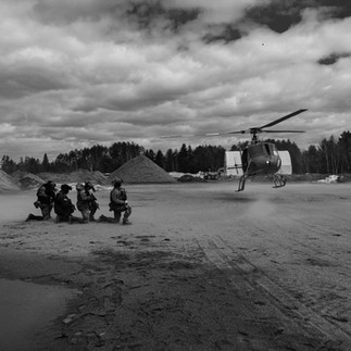 Teams wait to board as their helicopter lands