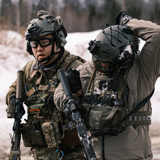 Airsoft players escorting casualties at milsim