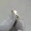 Thumbnail: Artisan-made 9ct yellow gold hammered wedding ring shown angled in hand