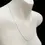 Thumbnail: Polished white gold 1.4mm curb chain necklace close-up on mannequin