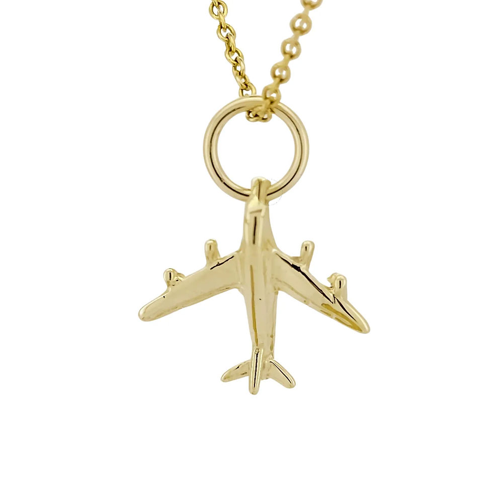 Close-up of 9ct yellow gold jet plane charm with polished finish