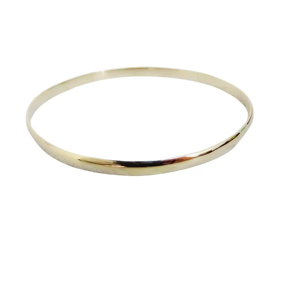 Slim handcrafted gold bangle displayed on white background