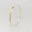 Thumbnail: Handcrafted 9ct yellow gold 4mm oval bangle displayed upright on stand